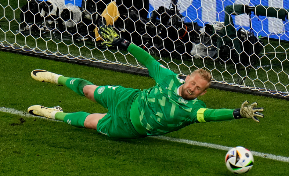 Denmark's goalkeeper Kasper Schmeichel fails to save the ball as Germany's Kai Havertz scores his side's opening goal during a round of sixteen match between Germany and Denmark at the Euro 2024 soccer tournament in Dortmund, Germany, Saturday, June 29, 2024