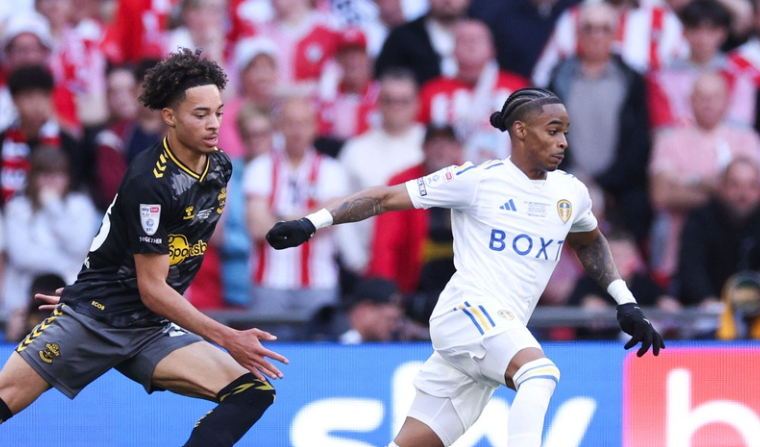 Leeds United's Dutch striker #10 Crysencio Summerville (R) vies with Southampton's English midfielder #23 Samuel Edozie (L) during the English Championship play-off final football match between Leeds United and Southampton at Wembley Stadium in London on May 26, 2024. 