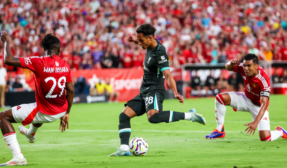 Aug 3, 2024; Columbia, South Carolina, USA; Liverpool midfielder Fabio Carvalho scores past Manchester United defender Aaron Wan-Bissaka (29) in the first half at Williams-Brice Stadium. 