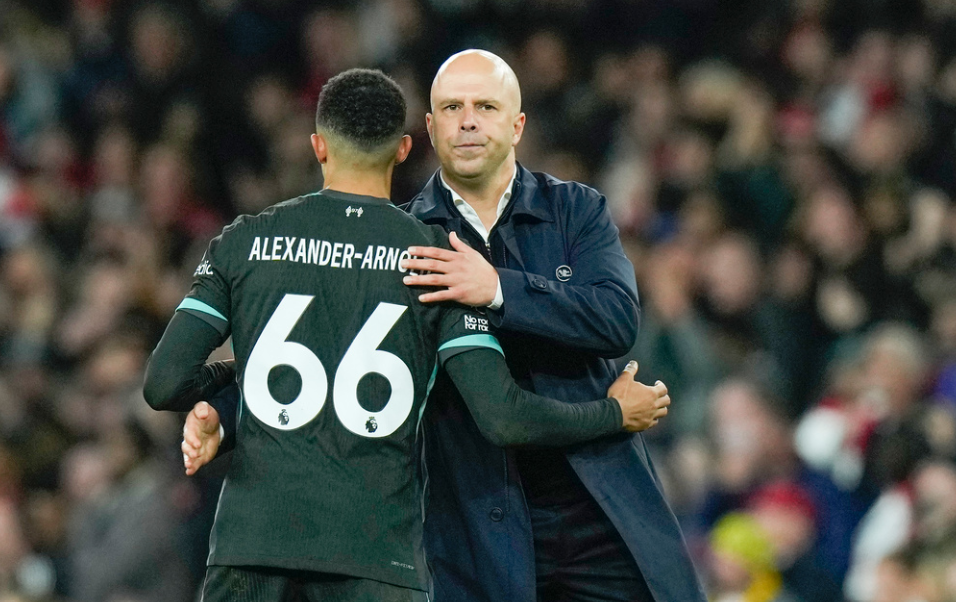 Liverpool's manager Arne Slot, right, greets Liverpool's Trent Alexander-Arnold at the end of the English Premier League soccer match between Arsenal and Liverpool, at Emirates Stadium in London, England, Sunday, Oct. 27, 2024.