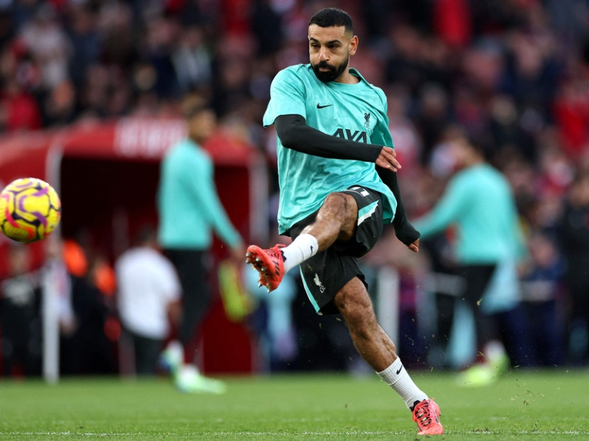 Liverpool's Egyptian striker #11 Mohamed Salah warms up ahead of the English Premier League football match between Arsenal and Liverpool at the Emirates Stadium in London on October 27, 2024.