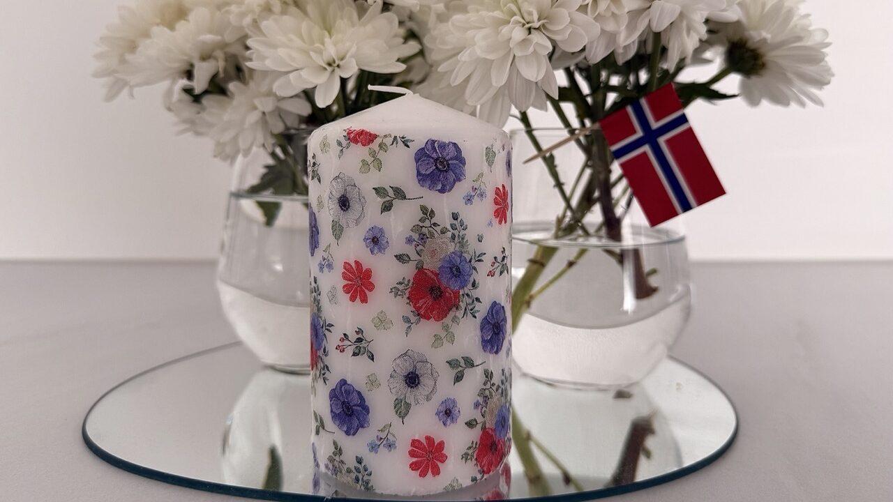 DIY-dekorasjon med egenlagde stearinlys og blomsterarrangement i hvite toner – ideelt for 17. mai eller sommerbordet. Kombiner brukte servietter og enkle lys for et bærekraftig og vakkert resultat.