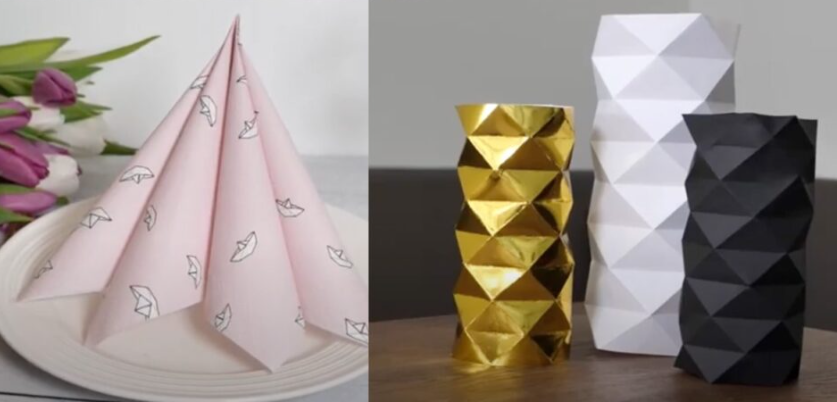 Til venstre en rosa serviett brettet slik at den står på tallerkenen. Til høyre tre vaser brettet i papir i gull, hvitt og sort