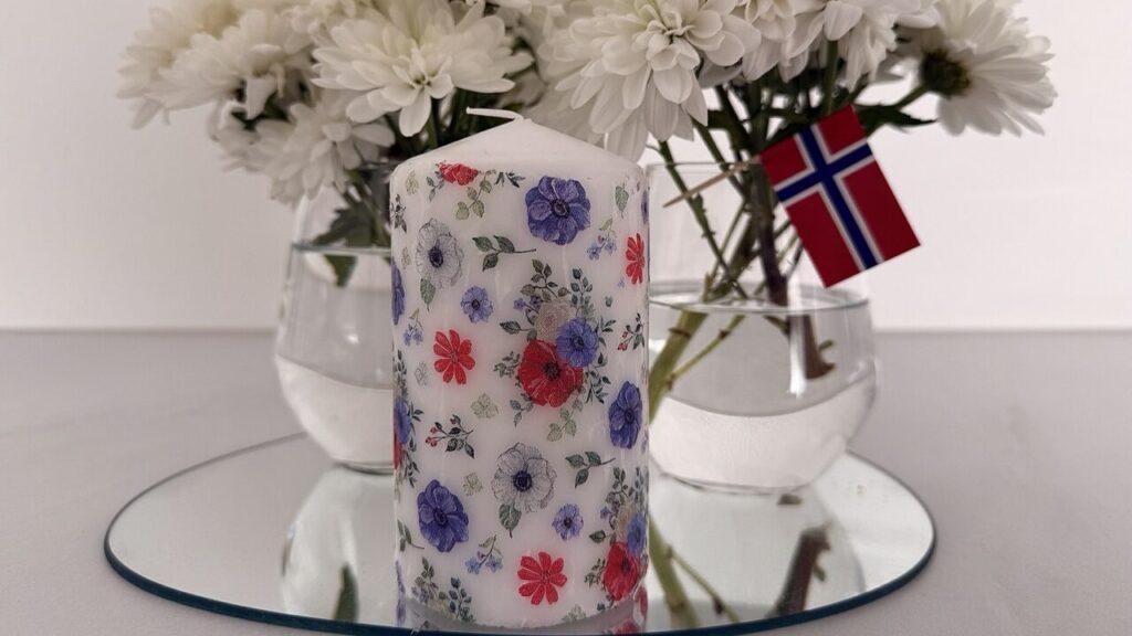 DIY-dekorasjon med egenlagde stearinlys og blomsterarrangement i hvite toner – ideelt for 17. mai eller sommerbordet. Kombiner brukte servietter og enkle lys for et bærekraftig og vakkert resultat.