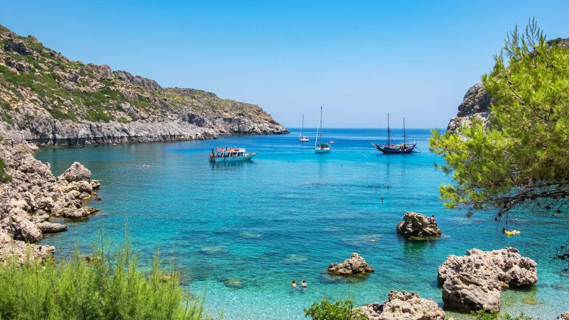 Bilde av nydelig blått hav på en restplass til hellas. på bilde ser du vakker gresk natur og krystallblått havn. Enten du tar turen til Rhodos, kreta eller Athen er mulighetene mange.